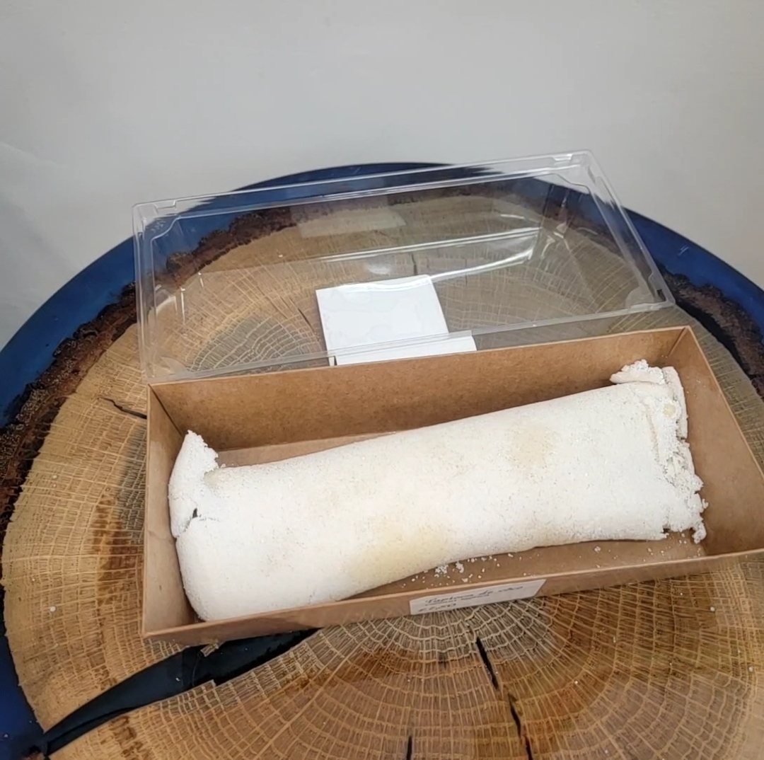 A coconut rocambole in its presentation box